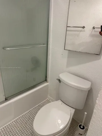 a bathroom with a sink a toilet a mirror and vanity