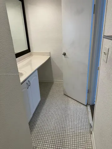 a bathroom with a shower sink and mirror