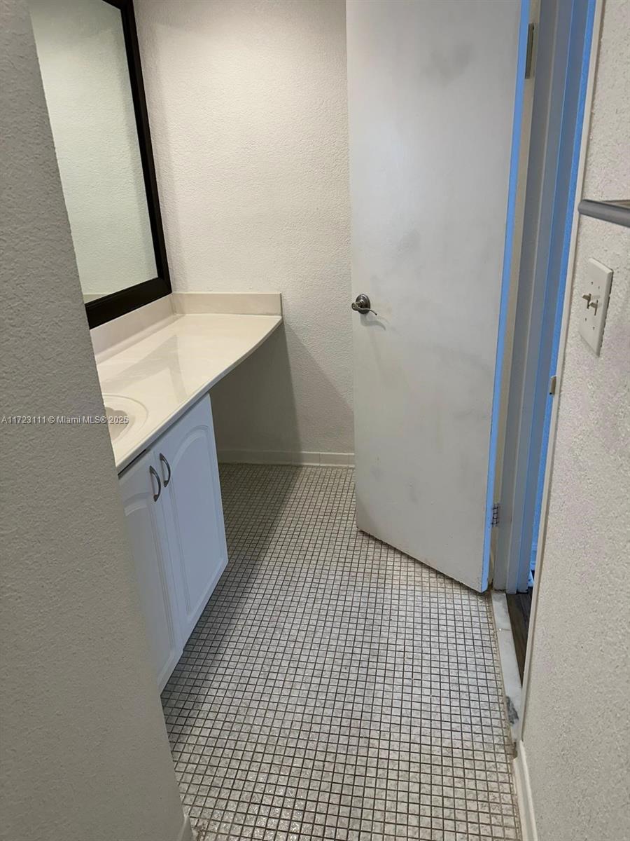 4001 South Ocean Drive, Unit 10D Hollywood, FL 33019 - Photo 17 of 28 a bathroom with a sink a toilet a mirror and vanity