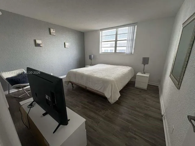 a room with a stove and a refrigerator