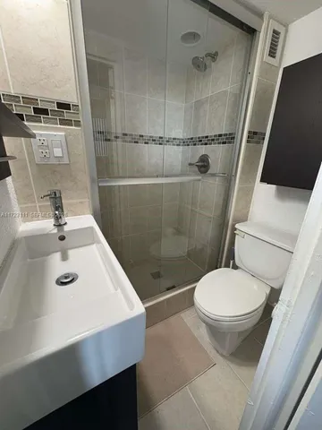 a kitchen with a refrigerator sink and cabinets