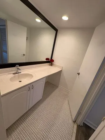 a kitchen with a refrigerator a stove top oven and cabinets