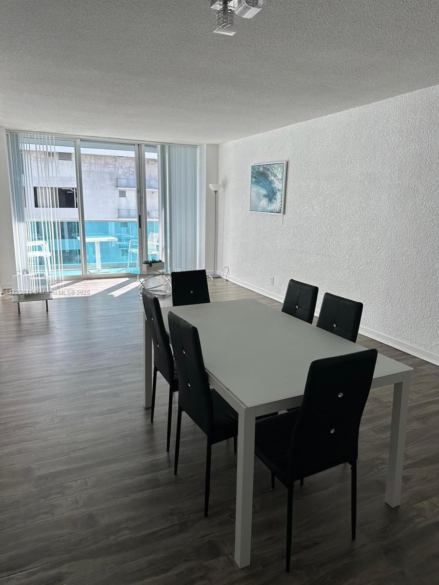 4001 South Ocean Drive, Unit 10D Hollywood, FL 33019 - Photo 5 of 28 a view of a dining room with furniture and wooden floor