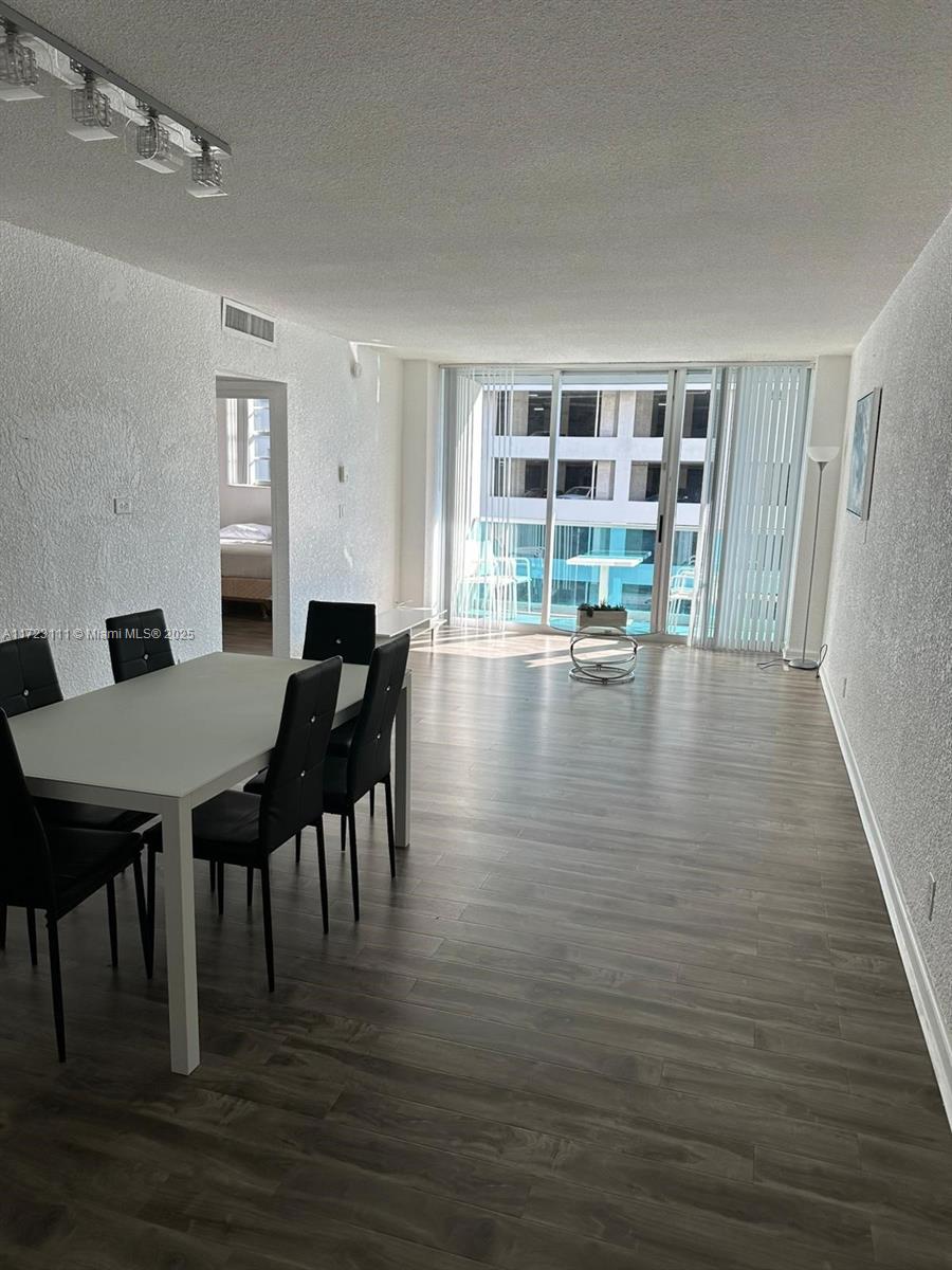 4001 South Ocean Drive, Unit 10D Hollywood, FL 33019 - Photo 6 of 28 a view of a dining room with furniture and wooden floor
