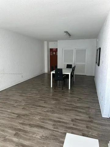 a view of a kitchen with sink and refrigerator