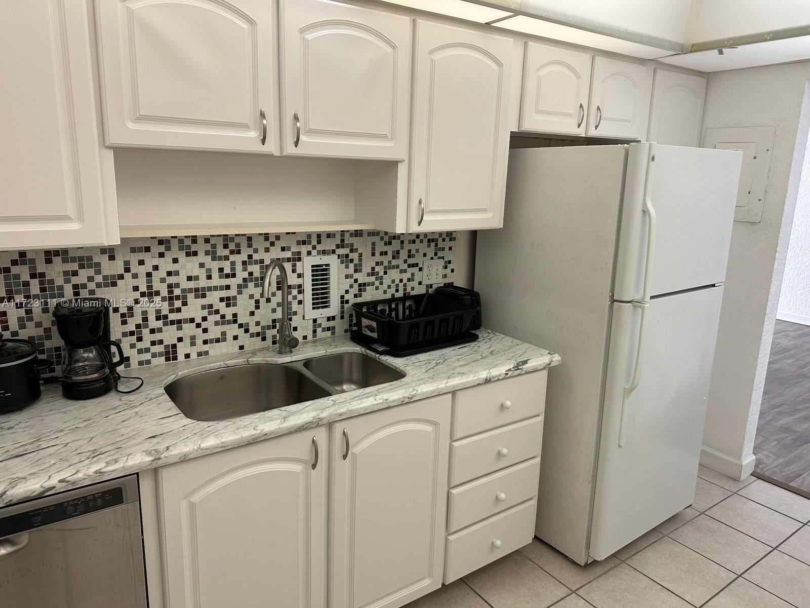 4001 South Ocean Drive, Unit 10D Hollywood, FL 33019 - Photo 9 of 28 a view of a kitchen with sink and refrigerator