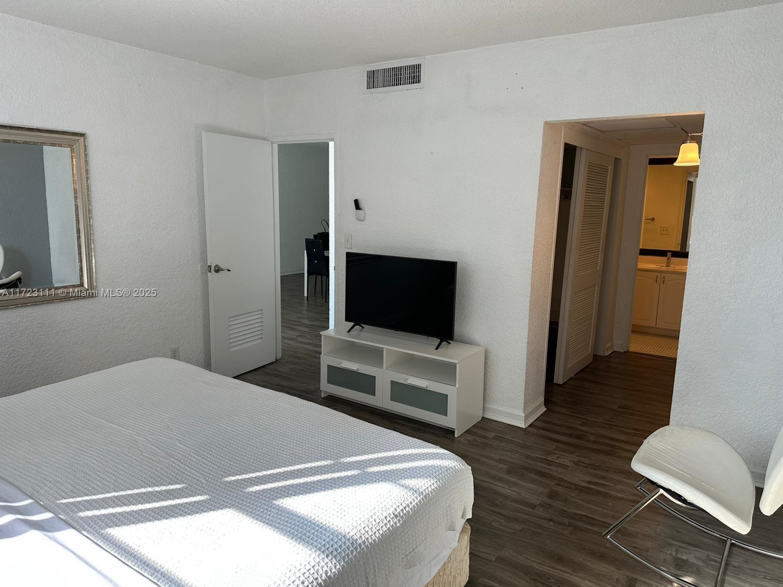 4001 South Ocean Drive, Unit 10D Hollywood, FL 33019 - Photo 10 of 28 a bedroom with a bed and a flat screen tv