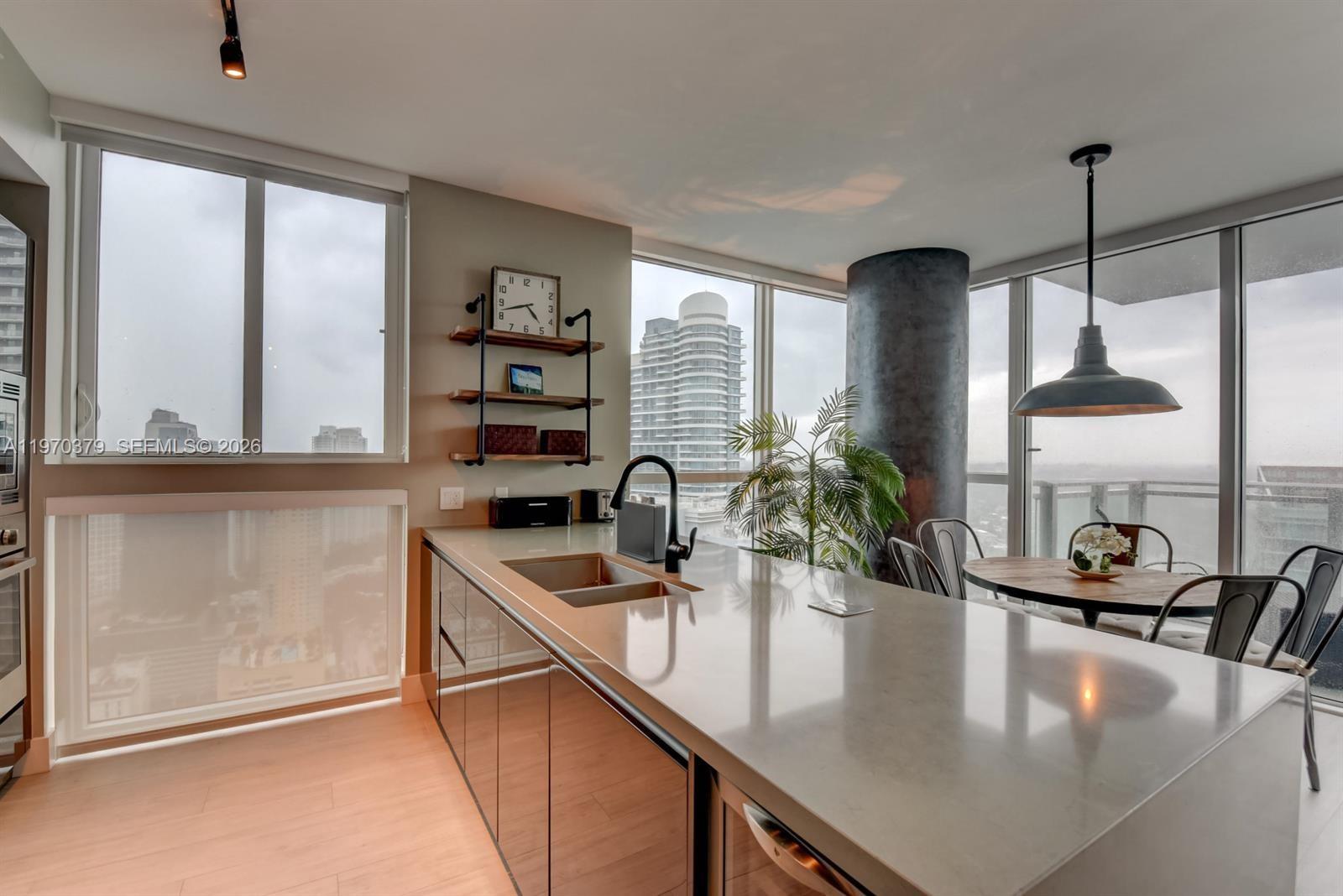 1080 Brickell Avenue, Unit 4101 Miami, FL 33131 - Photo 11 of 11 a kitchen with kitchen island a counter top space a sink and cabinets