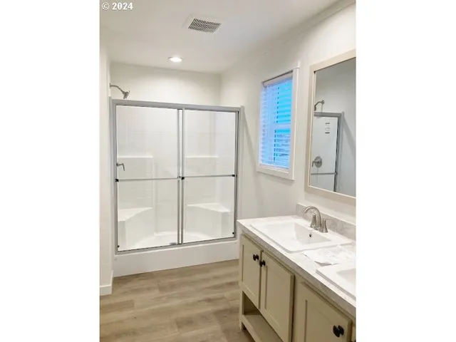 a spacious bathroom with a sink and a mirror