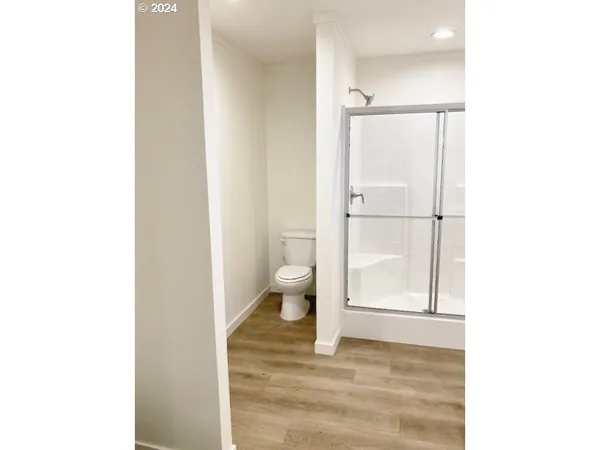 a bathroom with a glass shower door