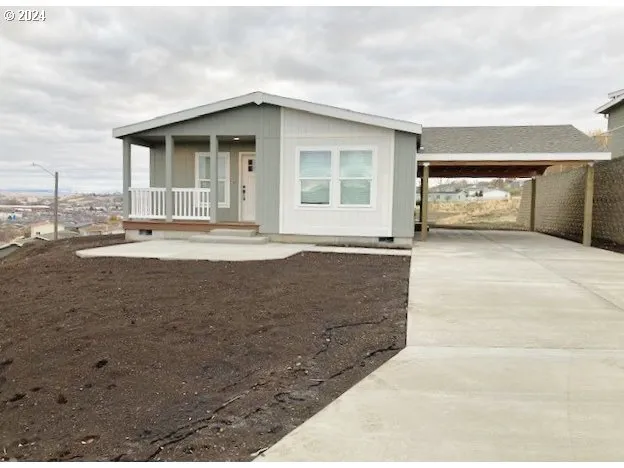 a view of a house with a swimming pool and sitting area