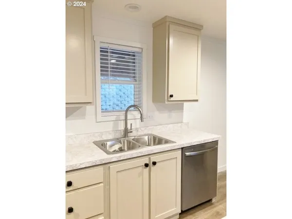 a stove top oven sitting inside of a kitchen