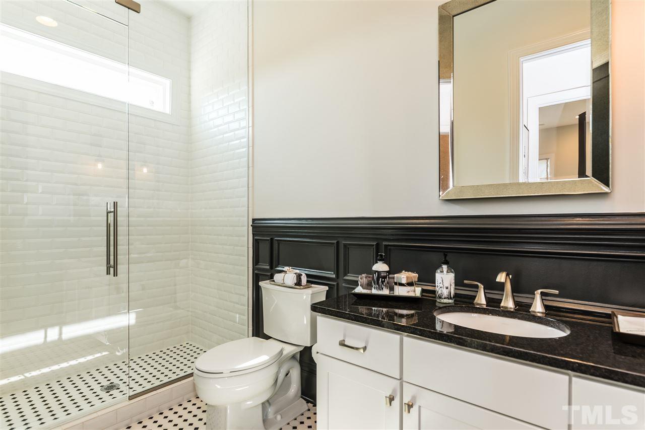 5285 Aleppo Lane Raleigh, NC 27613 - Photo 11 of 25 a bathroom with a granite countertop toilet sink and mirror