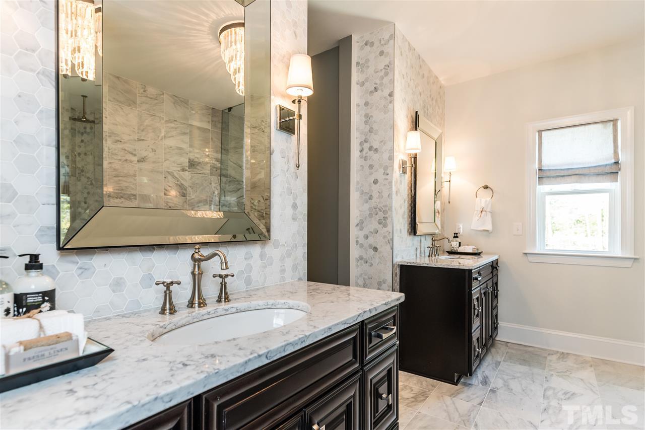 5285 Aleppo Lane Raleigh, NC 27613 - Photo 18 of 25 a bathroom with a granite countertop sink a mirror and a shower