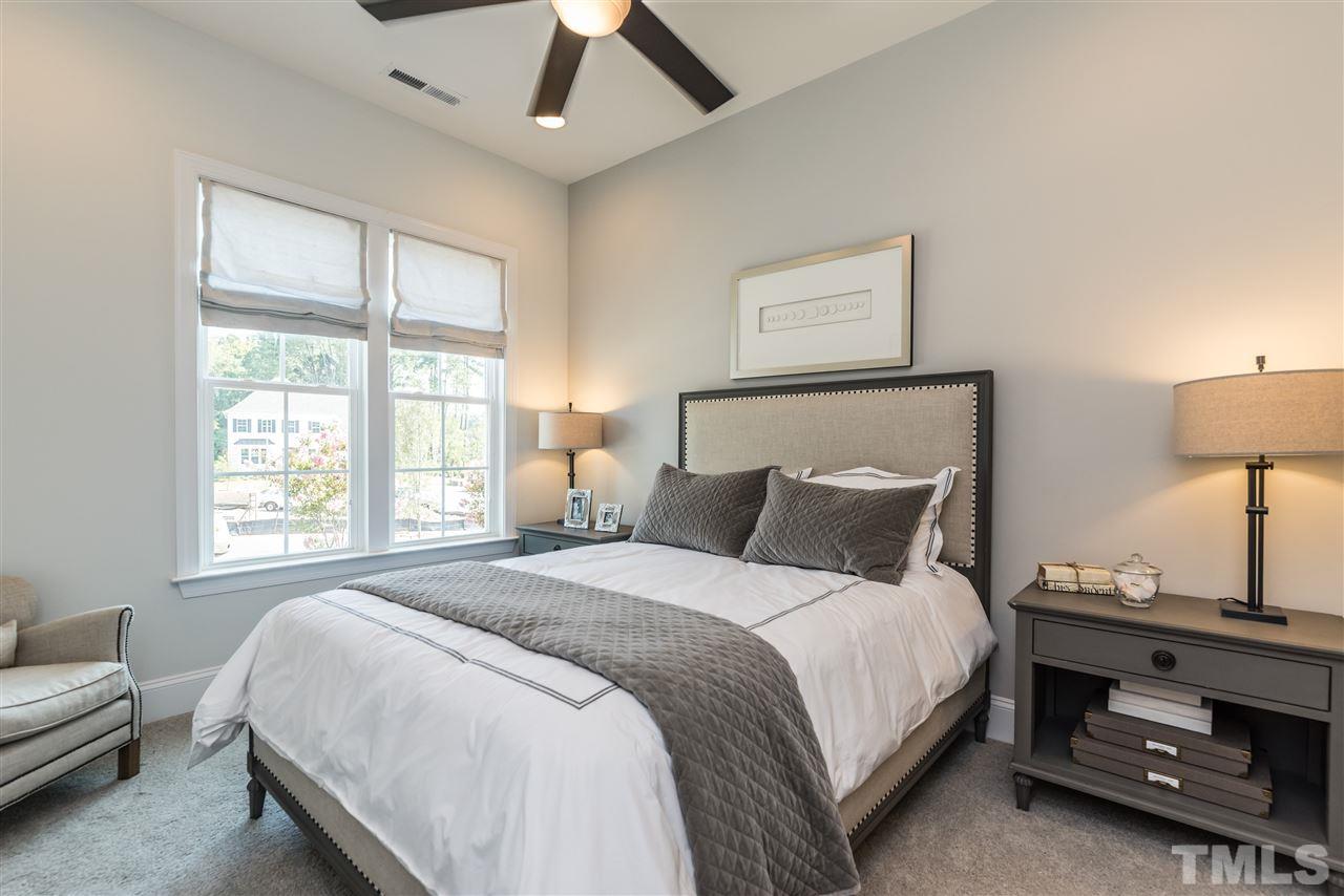 5285 Aleppo Lane Raleigh, NC 27613 - Photo 10 of 25 a bedroom with a bed a lamp and a window