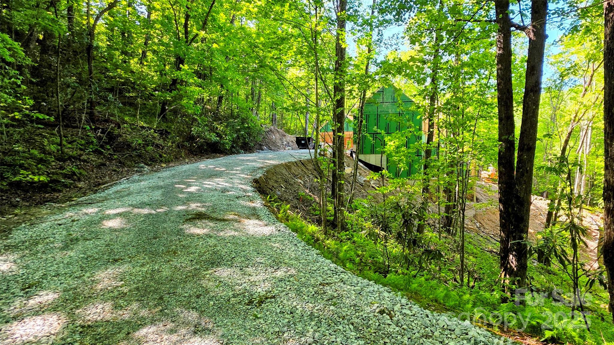 297 Easy Springs Road Sapphire, NC 28774 - Photo 20 of 34 a backyard of a house with lots of green space