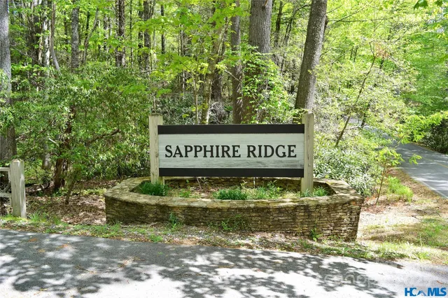 a view of swimming pool with seating area and trees in the background