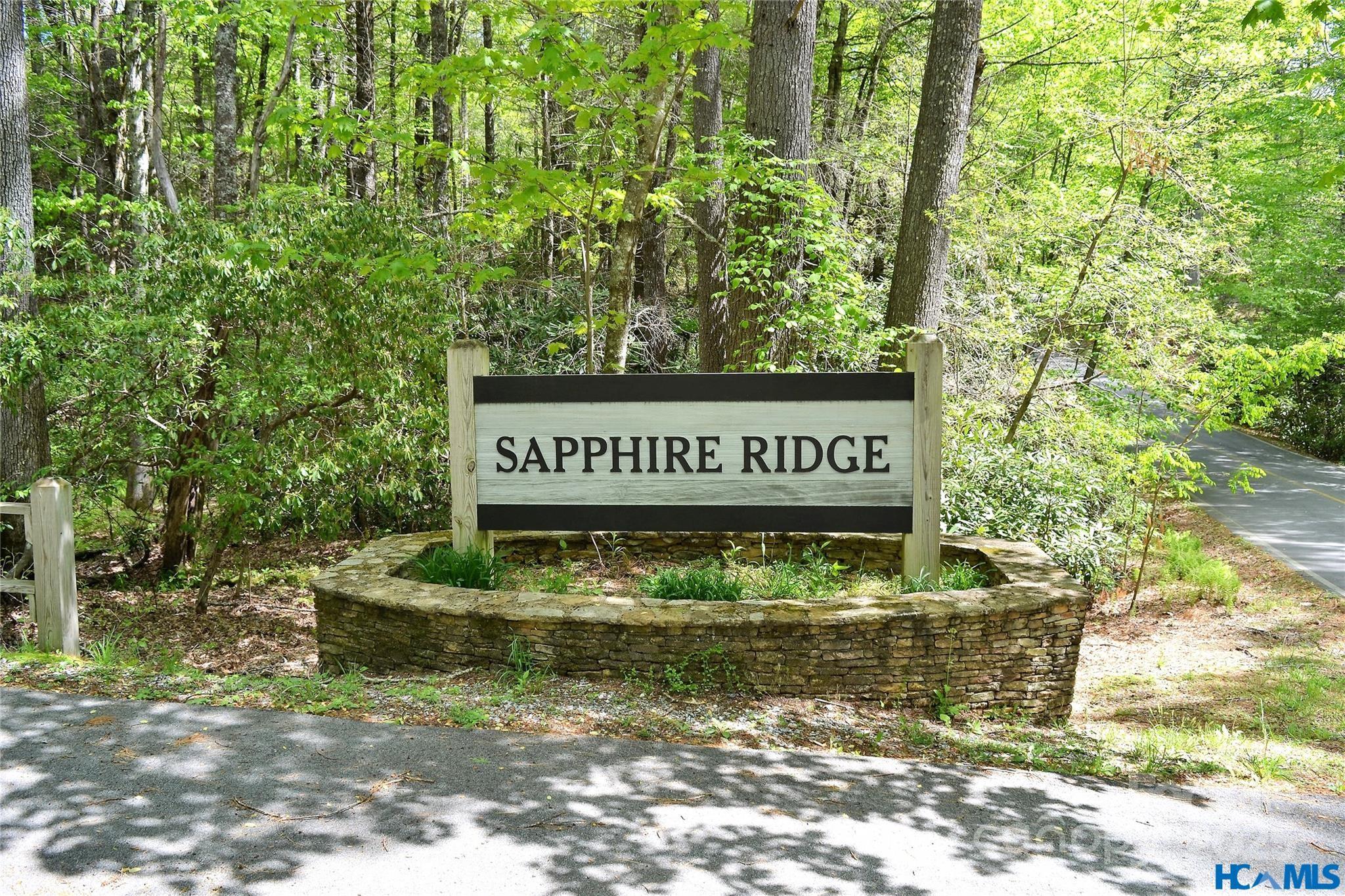 297 Easy Springs Road Sapphire, NC 28774 - Photo 30 of 34 a sign that is sitting on a brick wall