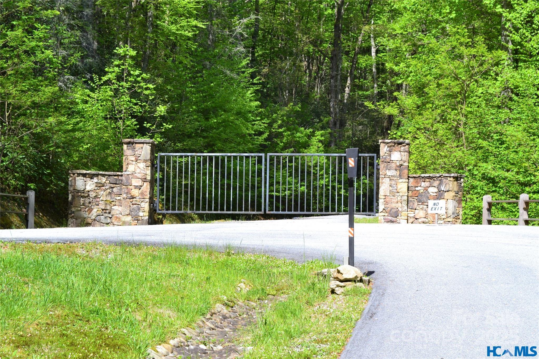 297 Easy Springs Road Sapphire, NC 28774 - Photo 31 of 34 a street view with a fence and trees