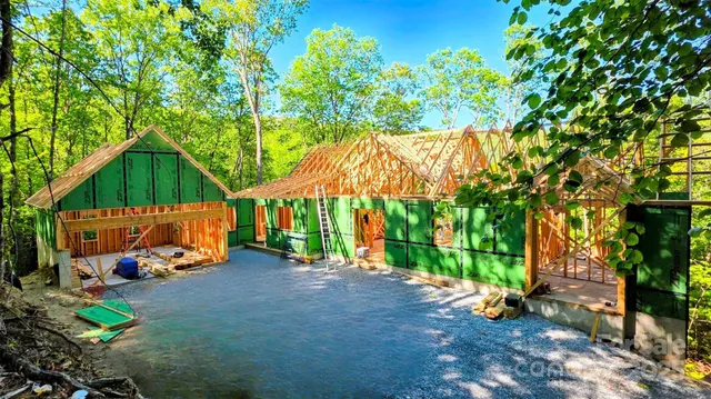 a small hurt is sitting in the middle of a yard