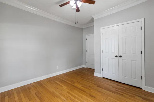 an empty room with a window and wooden floor