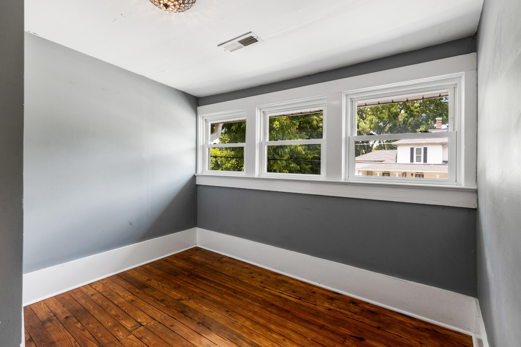253 15th Street Northwest Cleveland, TN 37311 - Photo 33 of 35 a view of an empty room with wooden floor and a window