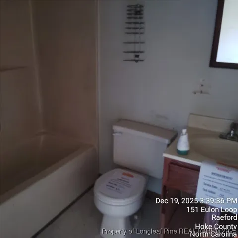 a bathroom with a toilet and a bathtub