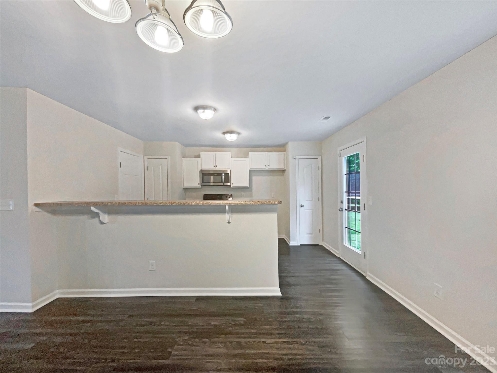 320 Peachtree Road Charlotte, NC 28216 - Photo 11 of 18 a view of a kitchen with wooden floor