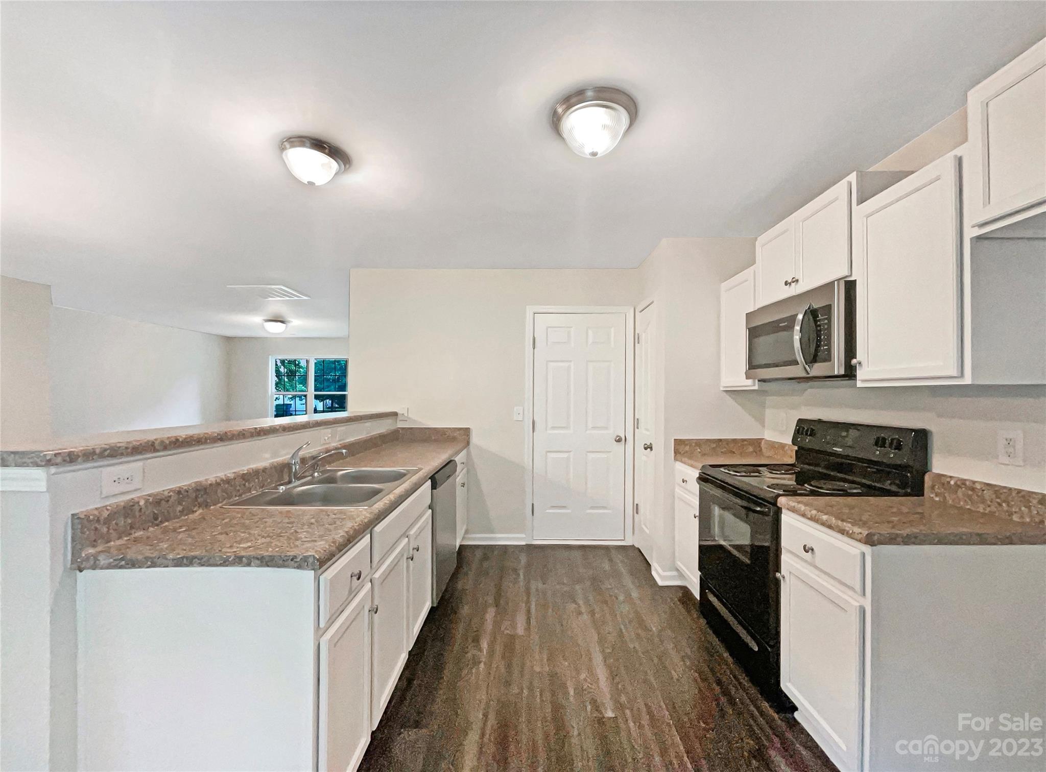 320 Peachtree Road Charlotte, NC 28216 - Photo 12 of 18 a kitchen with stainless steel appliances granite countertop a stove and a sink