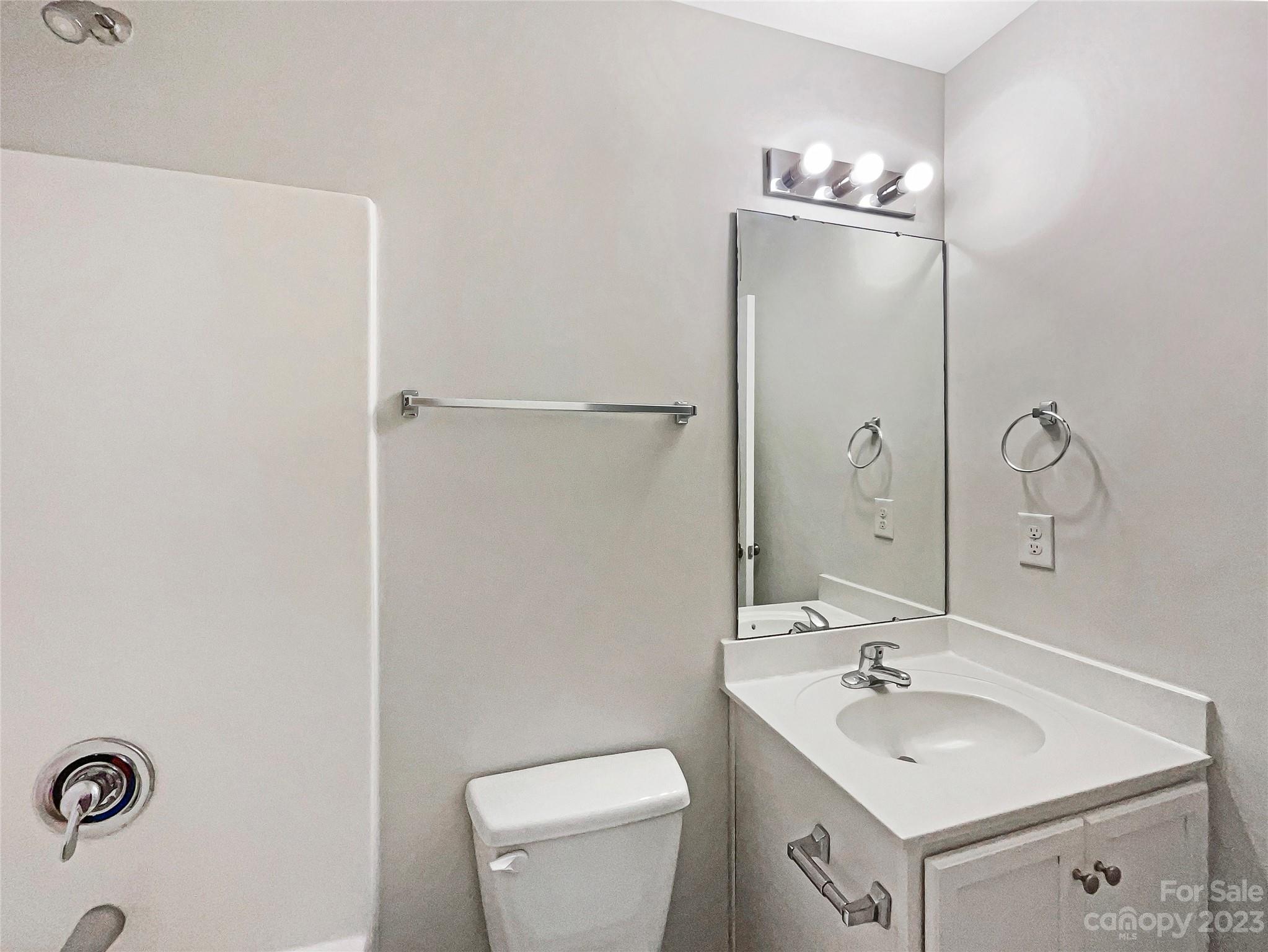 320 Peachtree Road Charlotte, NC 28216 - Photo 15 of 18 a bathroom with a toilet a sink and mirror