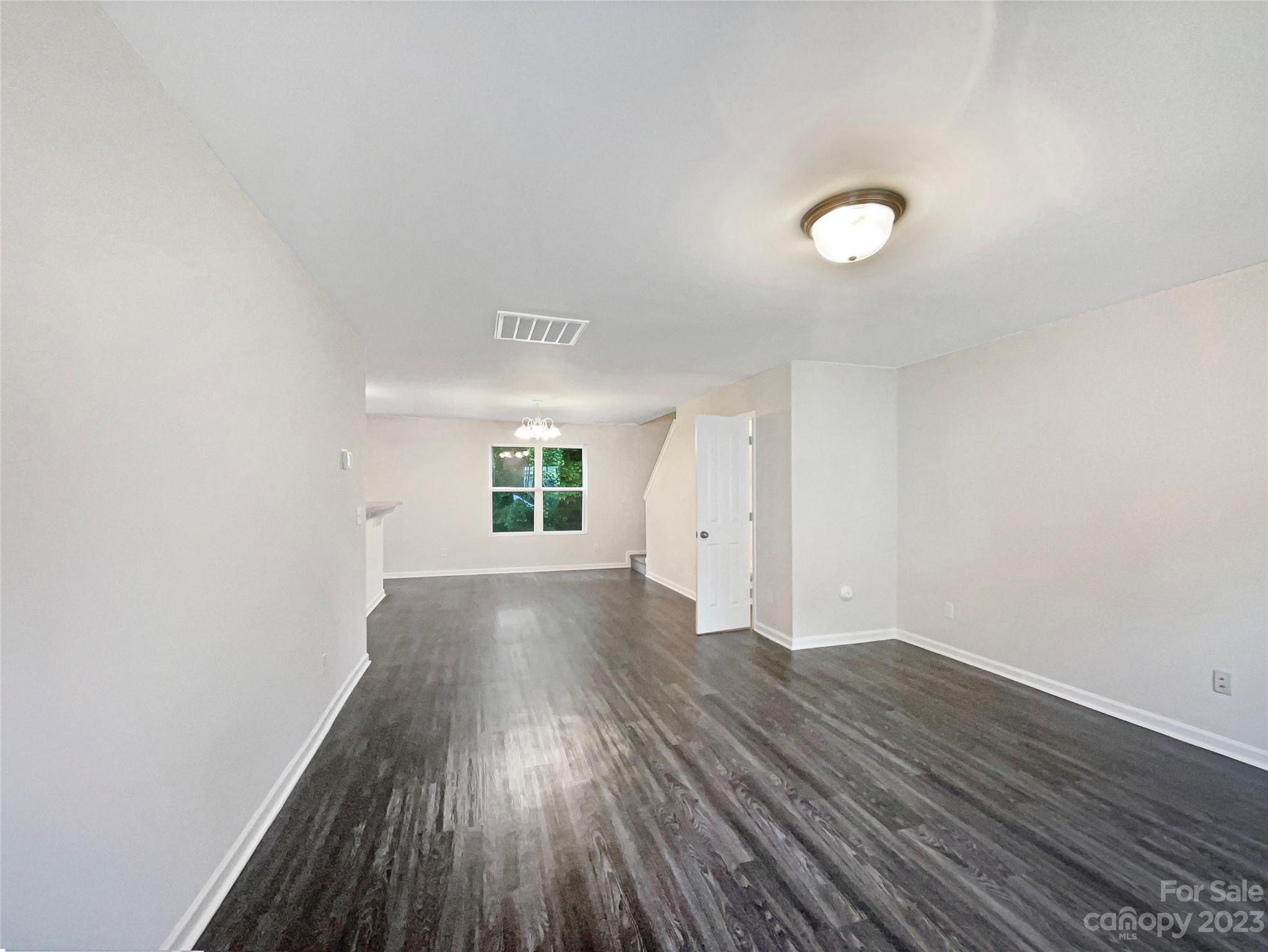 320 Peachtree Road Charlotte, NC 28216 - Photo 6 of 18 an empty room with wooden floor and windows