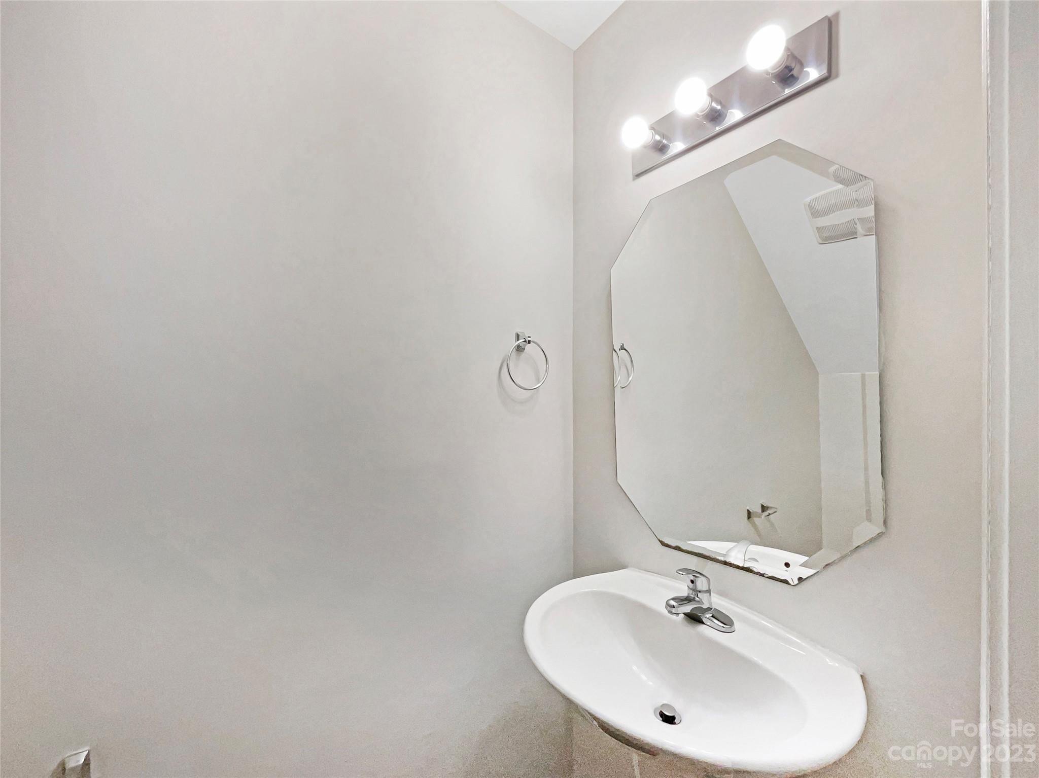 320 Peachtree Road Charlotte, NC 28216 - Photo 8 of 18 a bathroom with a sink and a mirror