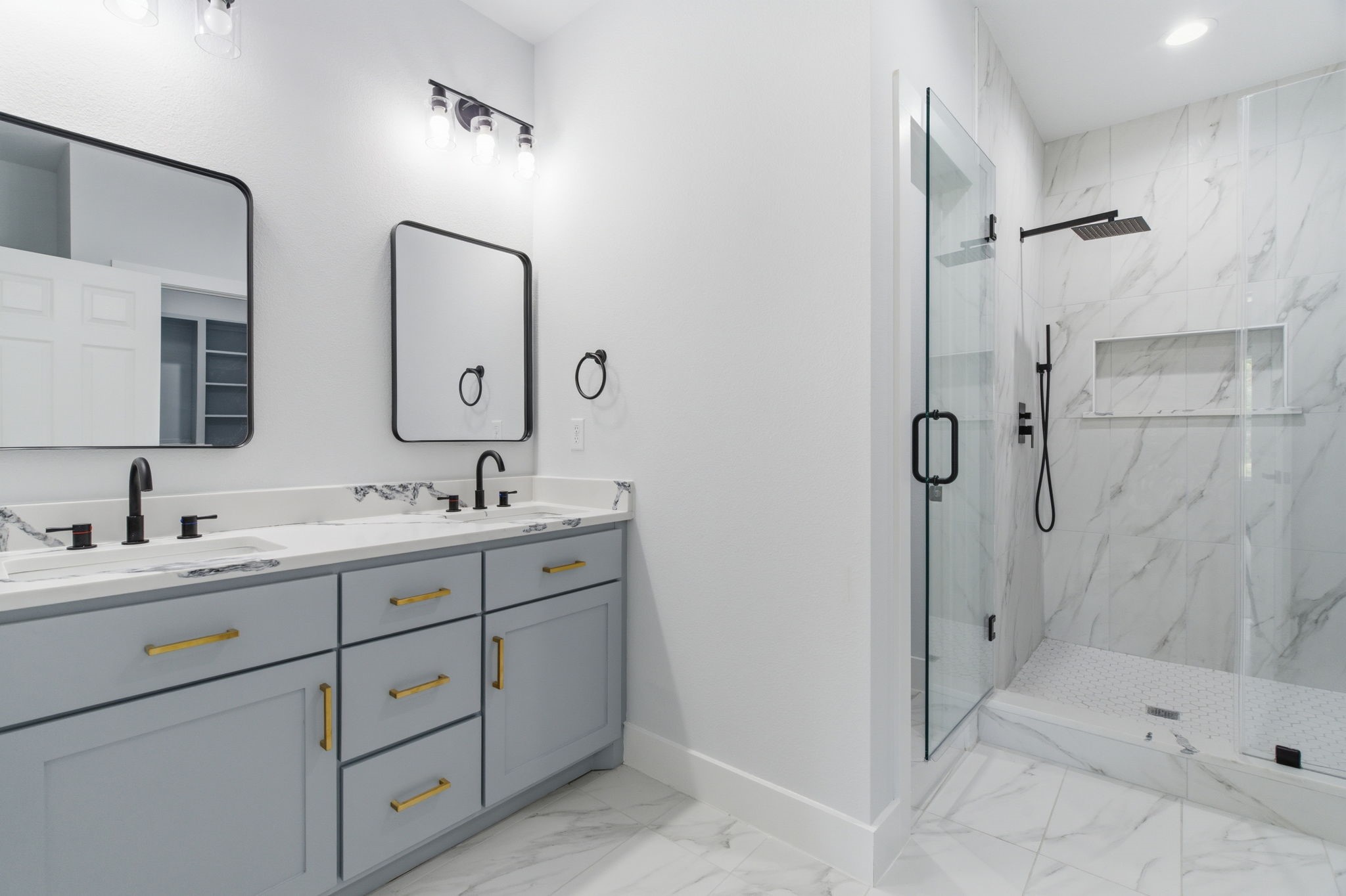 7040 Kinney Street Houston, TX 77087 - Photo 9 of 47 a bathroom with a double vanity sink mirror double and shower