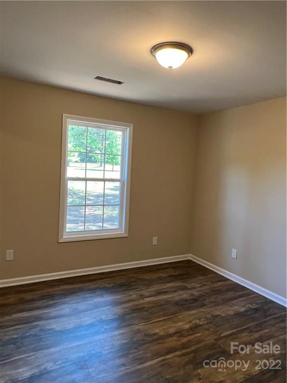 330 Holiday Road Lancaster, SC 29720 - Photo 4 of 12 an empty room with wooden floor and windows