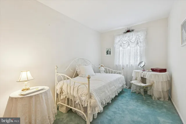 a bedroom with bed and a window