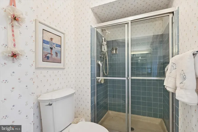 a bathroom with a shower toilet and sink