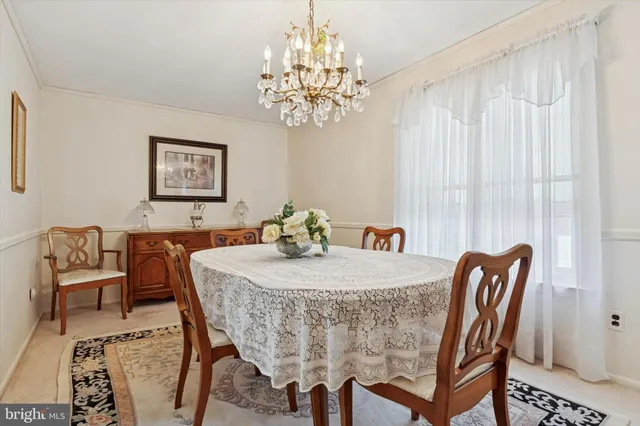 a dining room with furniture and chandelier