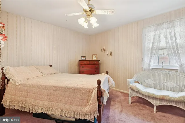 a bedroom with a bed and a couch