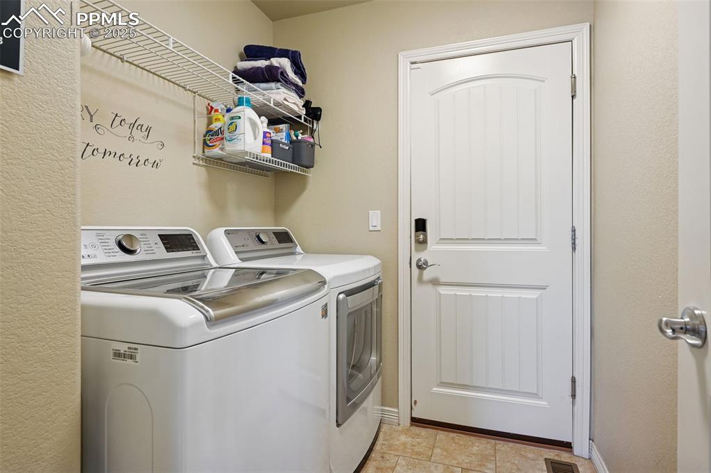 10214 Prairie Ridge Court Peyton, CO 80831 - Photo 13 of 42 a utility room with dryer and washer