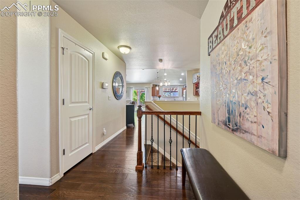 10214 Prairie Ridge Court Peyton, CO 80831 - Photo 3 of 42 a view of a hallway with wooden floor and entryway