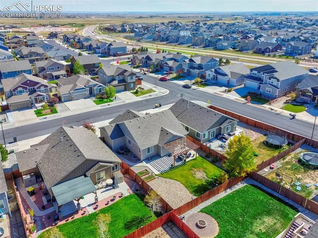 an aerial view of a house with a swimming pool outdoor seating and yard