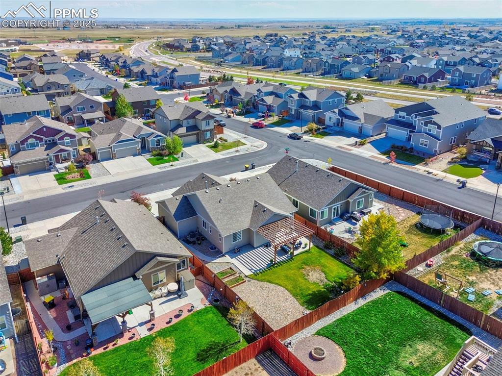 10214 Prairie Ridge Court Peyton, CO 80831 - Photo 40 of 42 an aerial view of a house with a swimming pool outdoor seating and yard