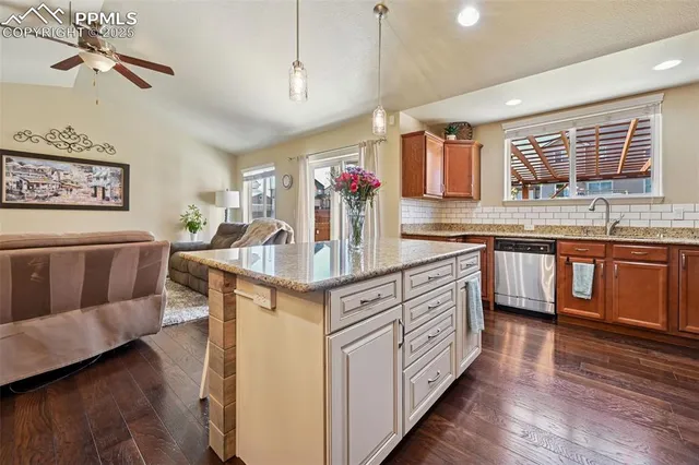 a kitchen with stainless steel appliances granite countertop a sink and cabinets