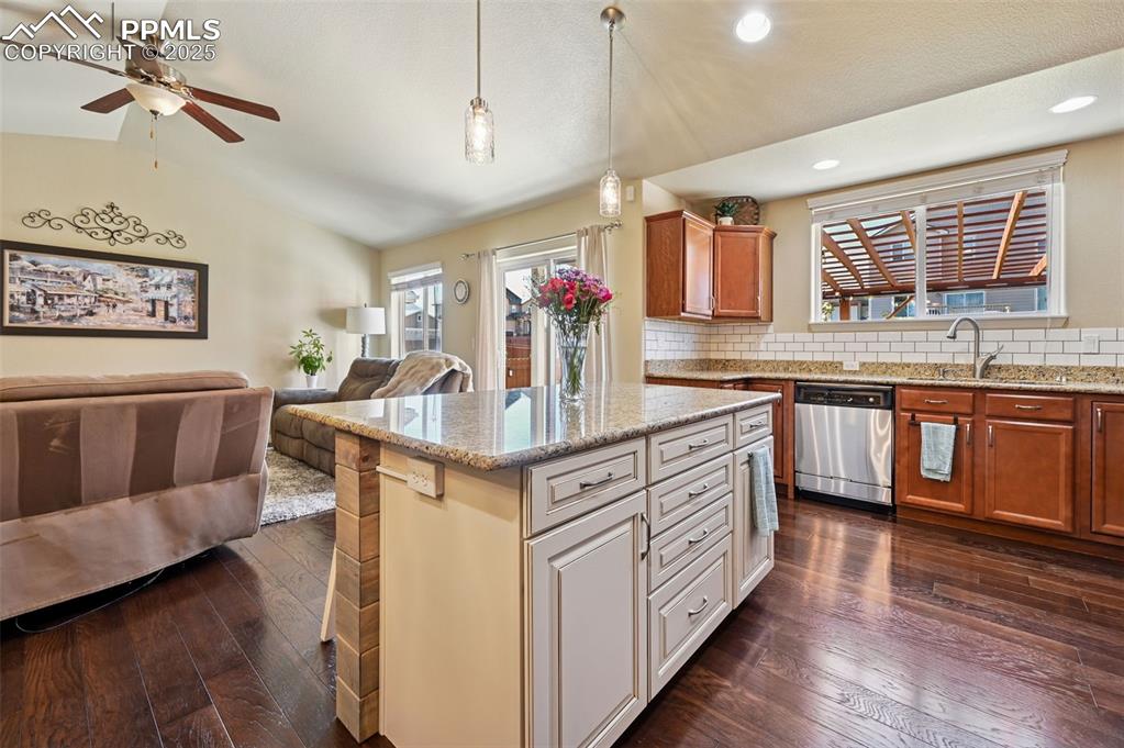 10214 Prairie Ridge Court Peyton, CO 80831 - Photo 6 of 42 a kitchen with stainless steel appliances granite countertop a sink and cabinets