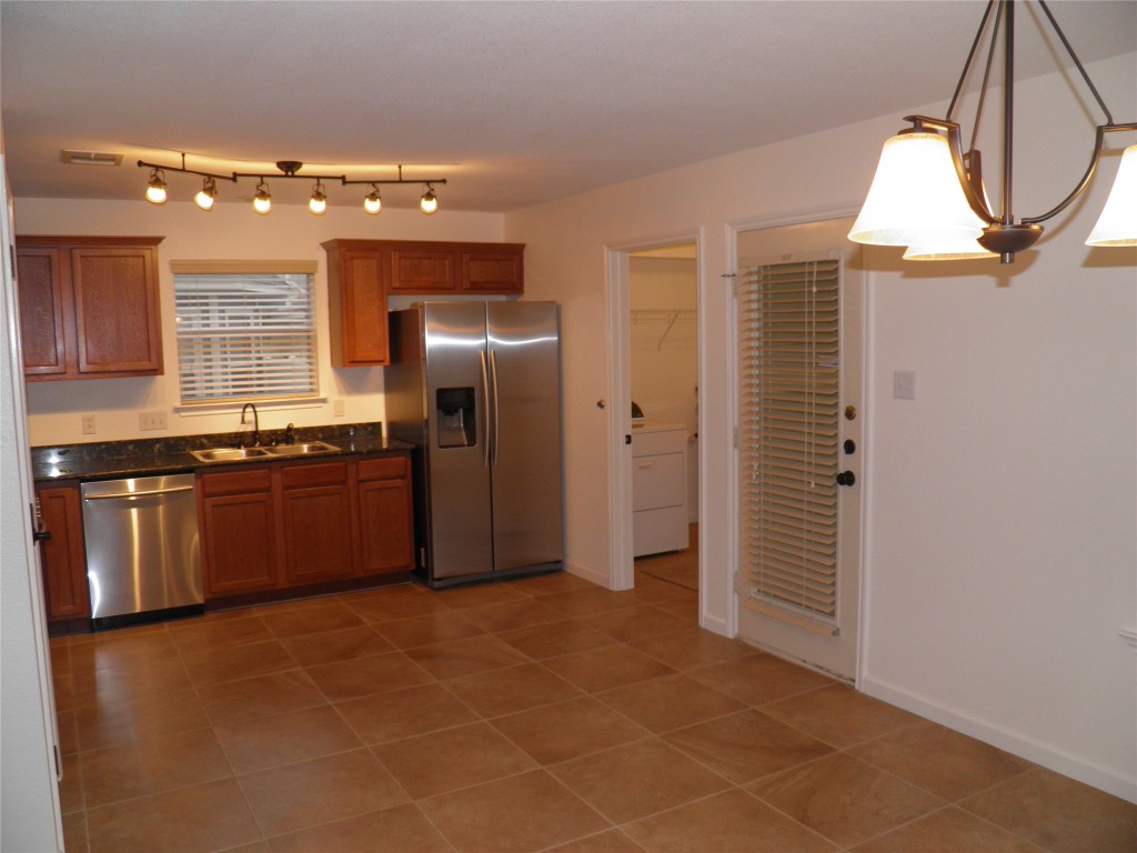 1515 Davis Mountain Loop Cedar Park, TX 78613 - Photo 3 of 6 a kitchen with stainless steel appliances a refrigerator and a sink