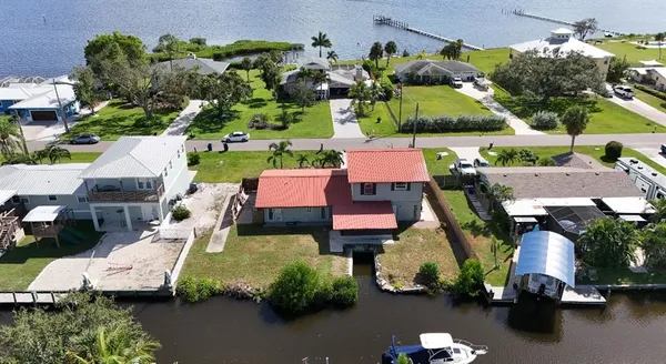 an aerial view of a house with a swimming pool yard and outdoor seating