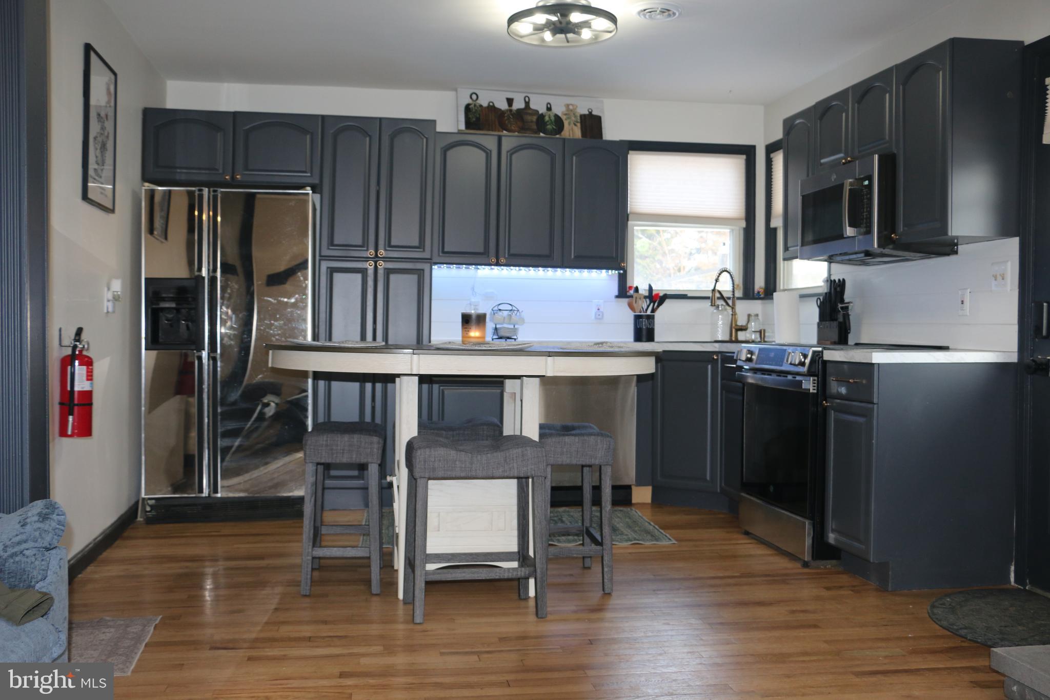 2717 Monmouth Road Jobstown, NJ 08041 - Photo 3 of 9 a kitchen with granite countertop a refrigerator stove microwave and sink