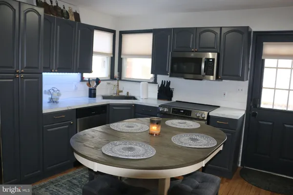 a kitchen with a sink a stove and kitchen island