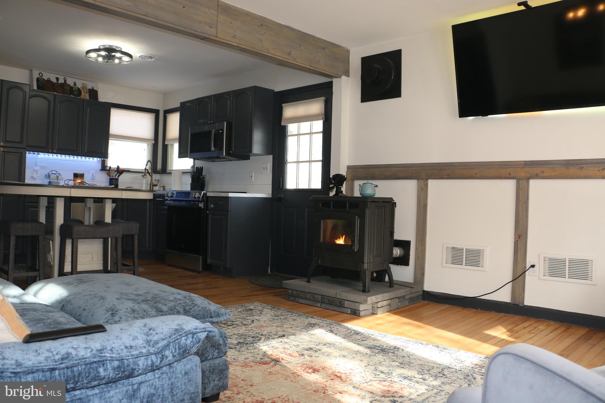 2717 Monmouth Road Jobstown, NJ 08041 - Photo 6 of 9 a living room with kitchen furniture and a flat screen tv