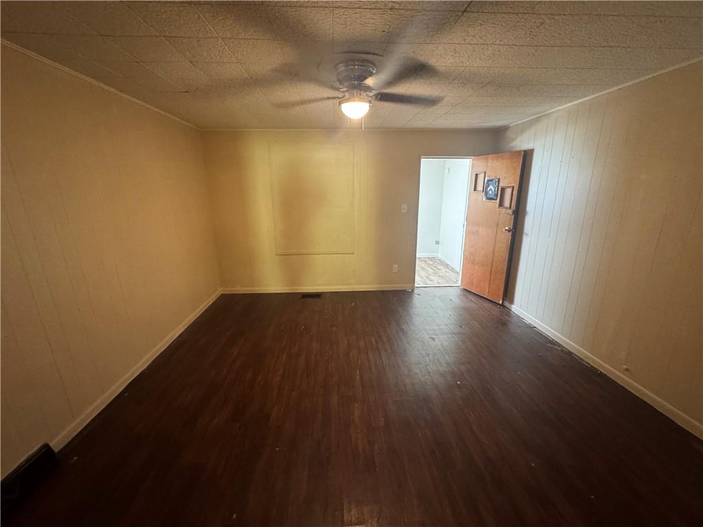 713 Freeport Road, Unit B Creighton, PA 15030 - Photo 5 of 11 an empty room with wooden floor and windows with curtains